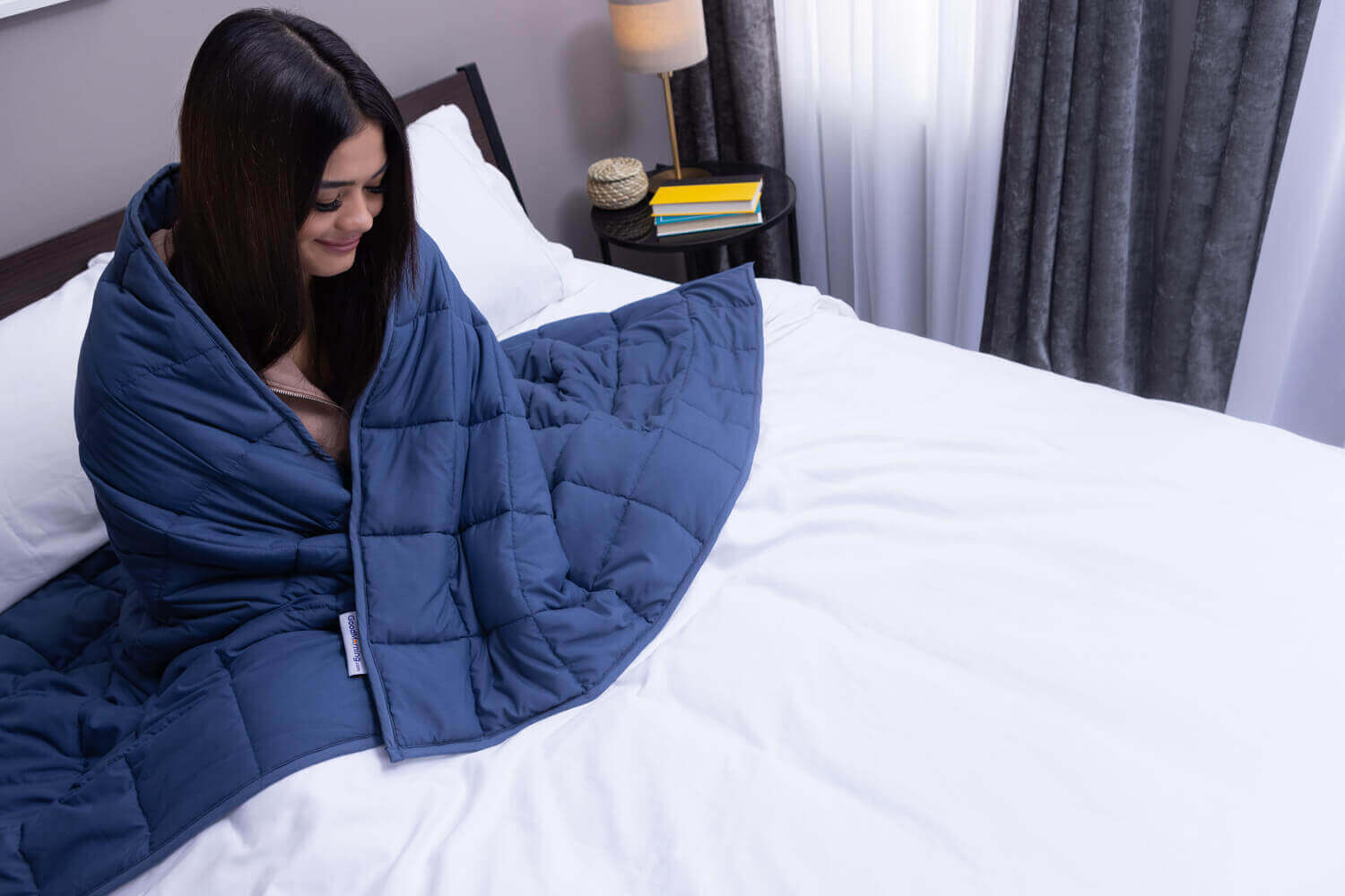 Woman with a Classic Weighted Blanket draped around her shoulders