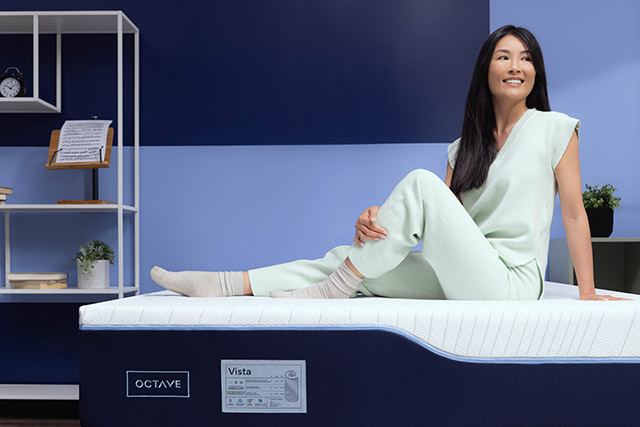 Woman sitting on an Octave Vista mattress