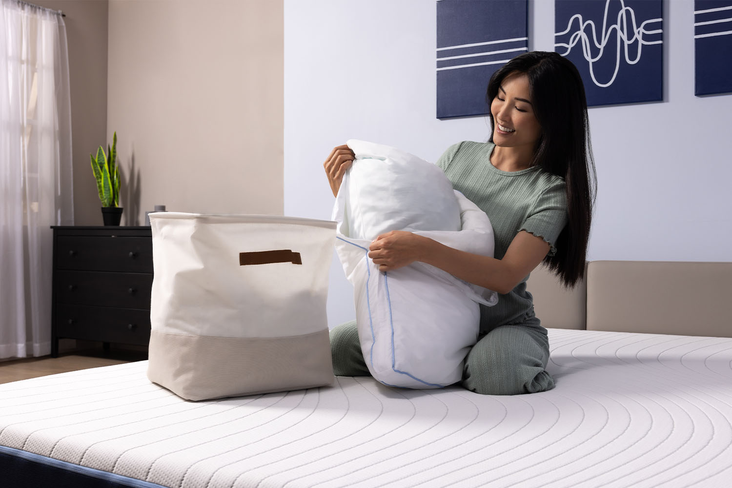Woman removing the pillow cover and placing it in the laundy basket