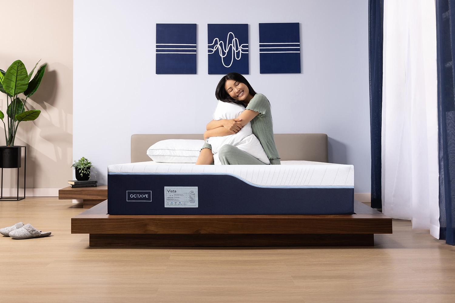 Woman on her Octave mattress hugging a memory foam pillow
