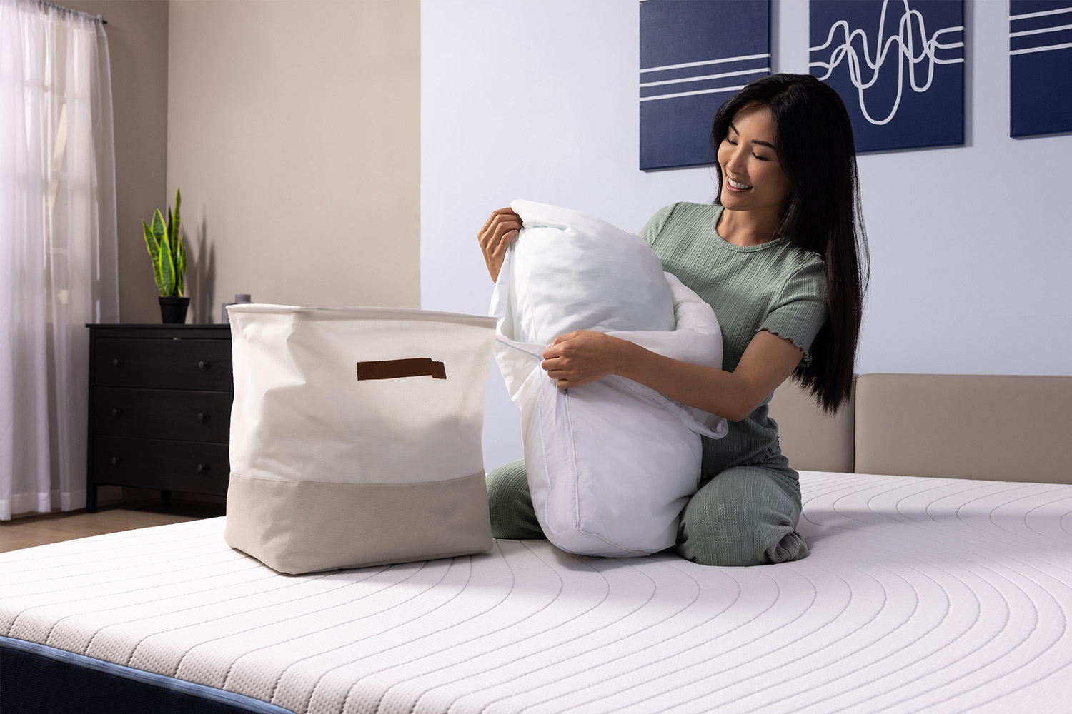 Woman removing the pillow cover and placing it in the laundy basket