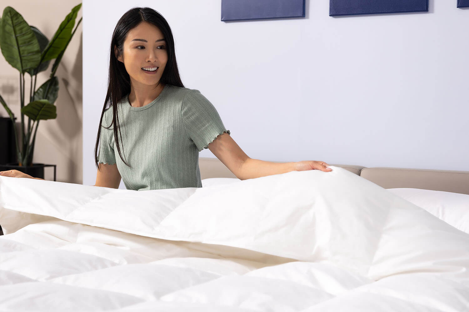 Woman on bed wrapped in Octave Down Duvet